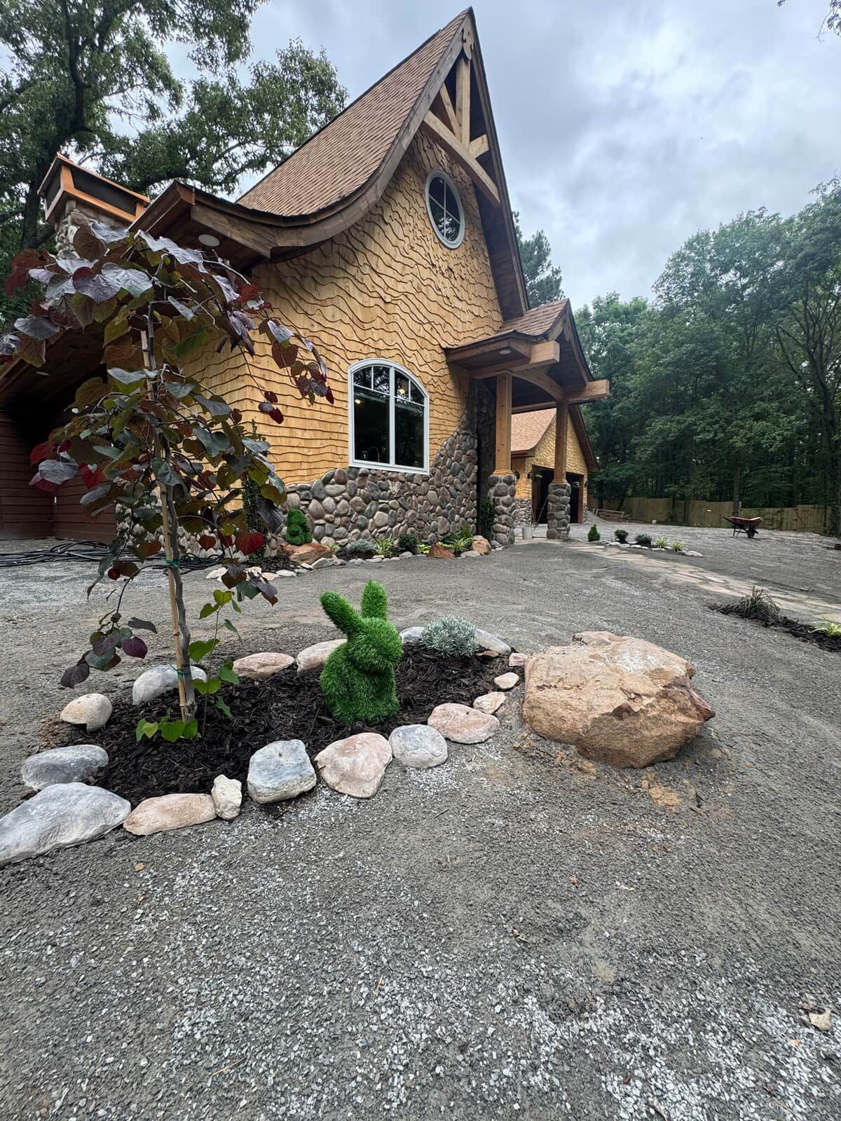 A house with a unique architectural style, featuring a stone facade and a curved roof.