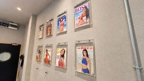 A wall with framed magazine covers.