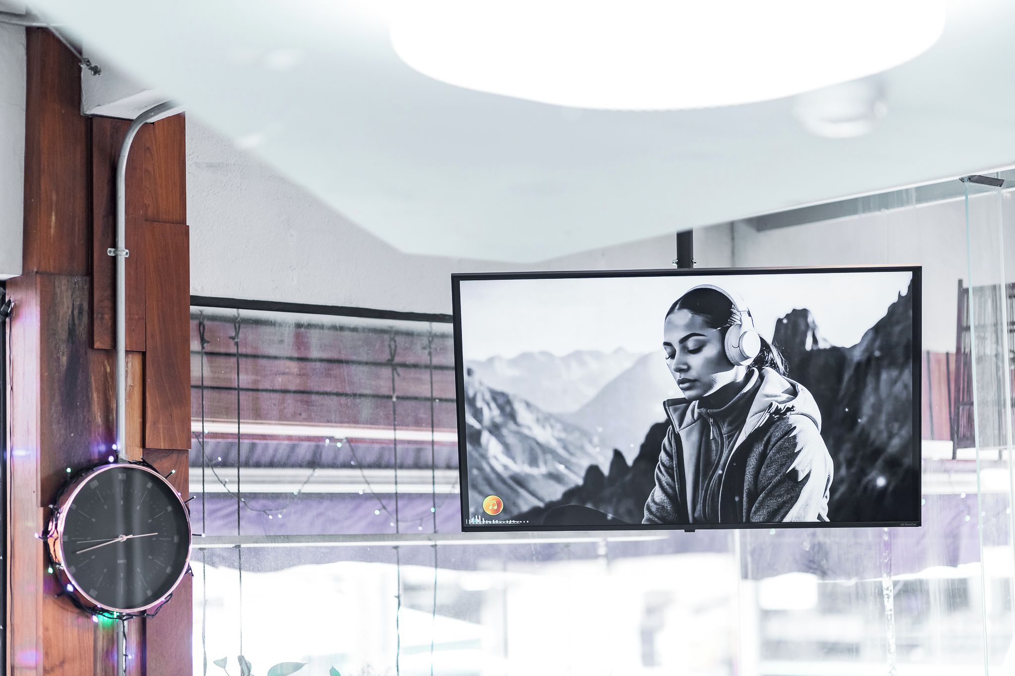 A television mounted on a wall with a mountainous background.