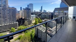 A high-rise building with a view of a cityscape, including several skyscrapers and a clear sky. - Platinum Towers by Interhome (Warsaw)
