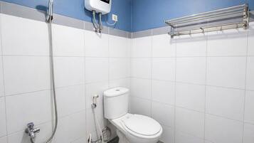 A bathroom with a toilet, a shower, and a hand dryer.