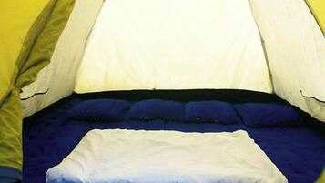 A tent with a bed inside.