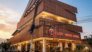 A two-story building with a sign reading 'Lazy Gibson Hostel.' - Lazy Gibbon 2 Chiang Mai - Haiya (Chiang Mai)