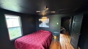 A room with a bed, a window, a painting, and a door. - Dark & Cozy Vibez with Appalachian Mountain Views (Candler)