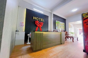 A hotel reception desk with a 'HOTEL' sign and a red bow decoration. - Phuc Khang Airport Hotel (Ho Chi Minh City)