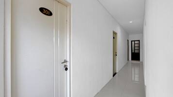 A corridor with doors numbered 301, leading to rooms.