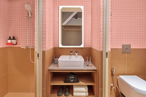 A bathroom with a shower, sink, and a mirror. - lyf Chinatown Singapore (Singapore)