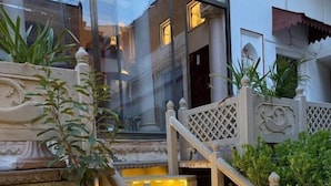 A stone staircase with illuminated steps, surrounded by potted plants. - Rudreshwar Mahadeo Kothi (Varanasi)