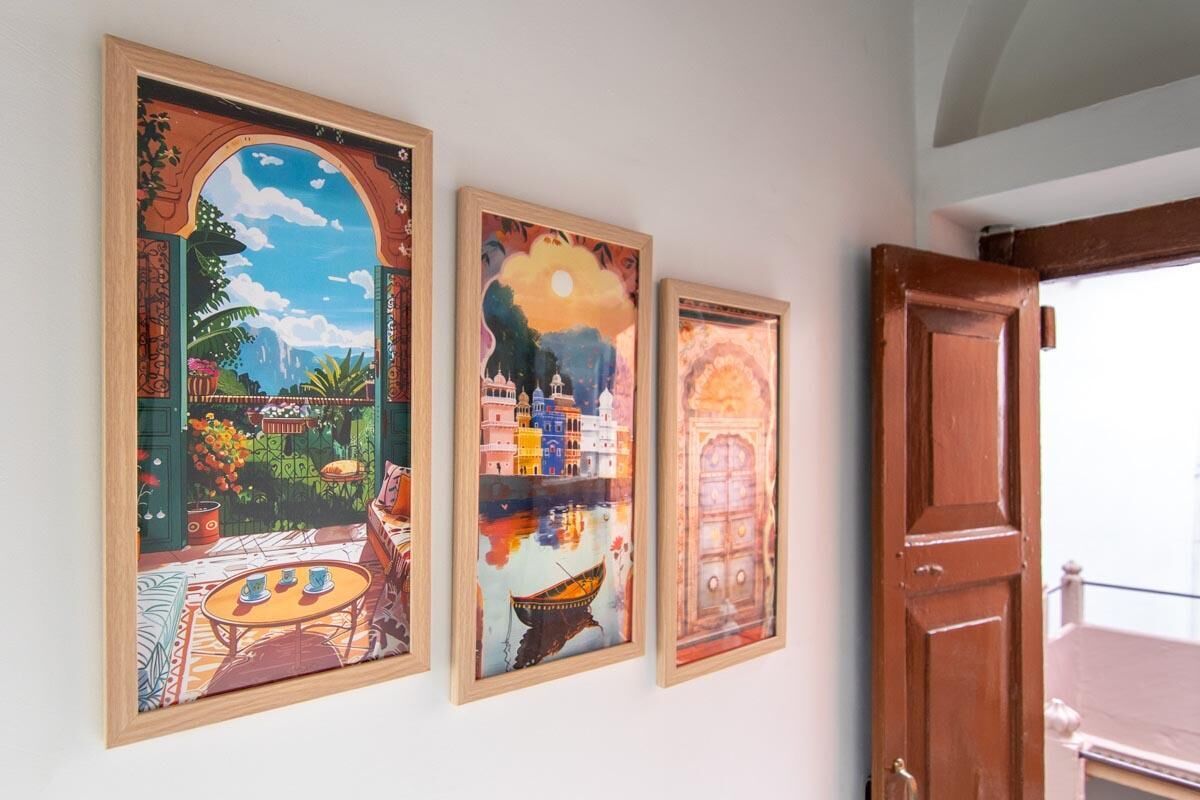 Three framed artworks on a wall.