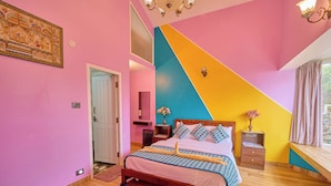 A bedroom with a bed, bedside tables, a window with curtains, a door, and a wall with a geometric design. - Emy Misty Charm Villa Ooty by VOYE HOMES (Ootacamund)