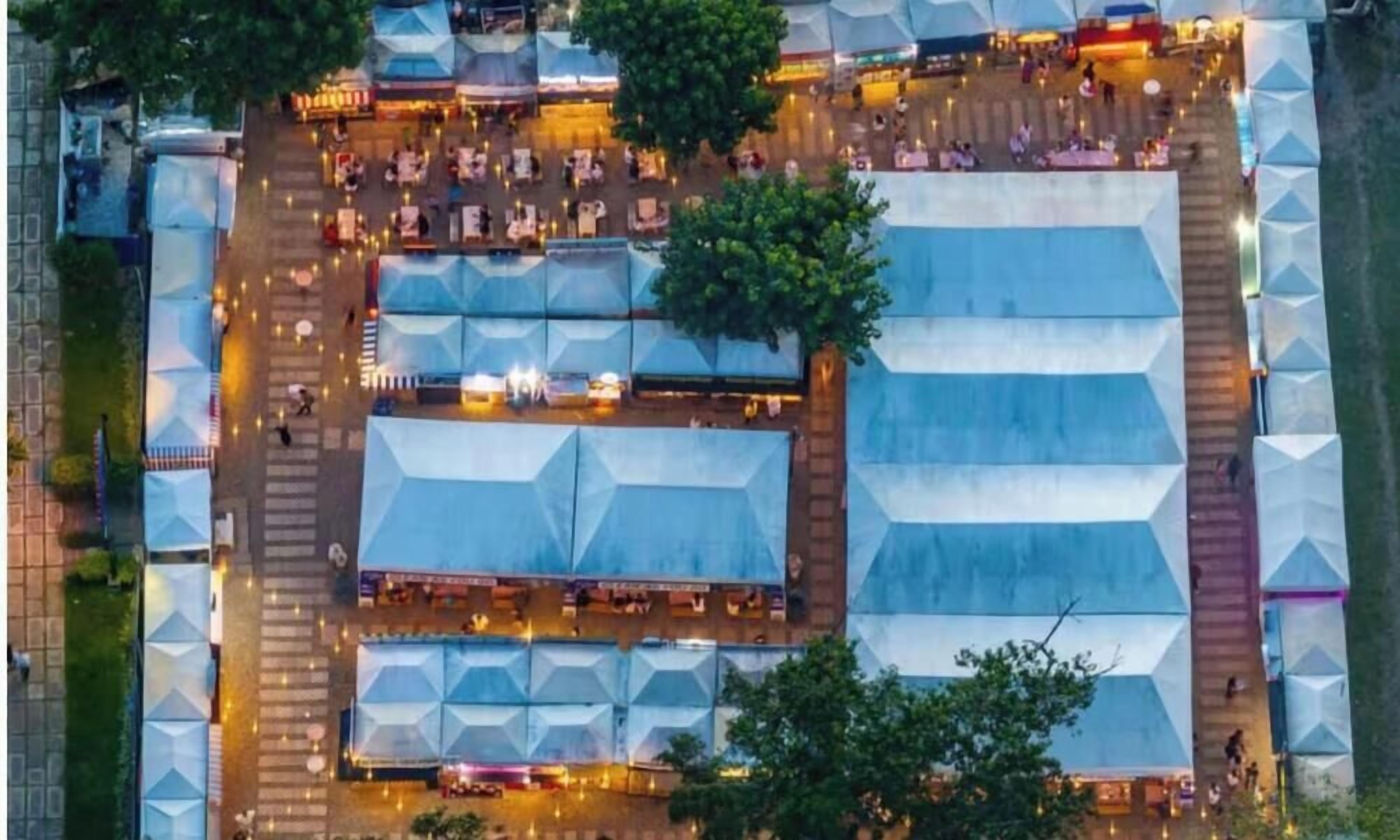 A large open-air venue with multiple tents and a central open space.