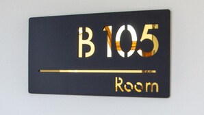 A room number sign with 'B 105' and 'Room' text.