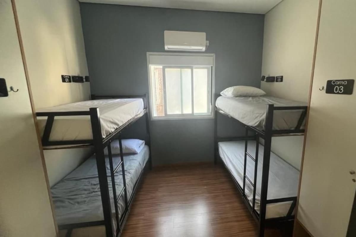 A compact room with bunk beds, a window, and a door.