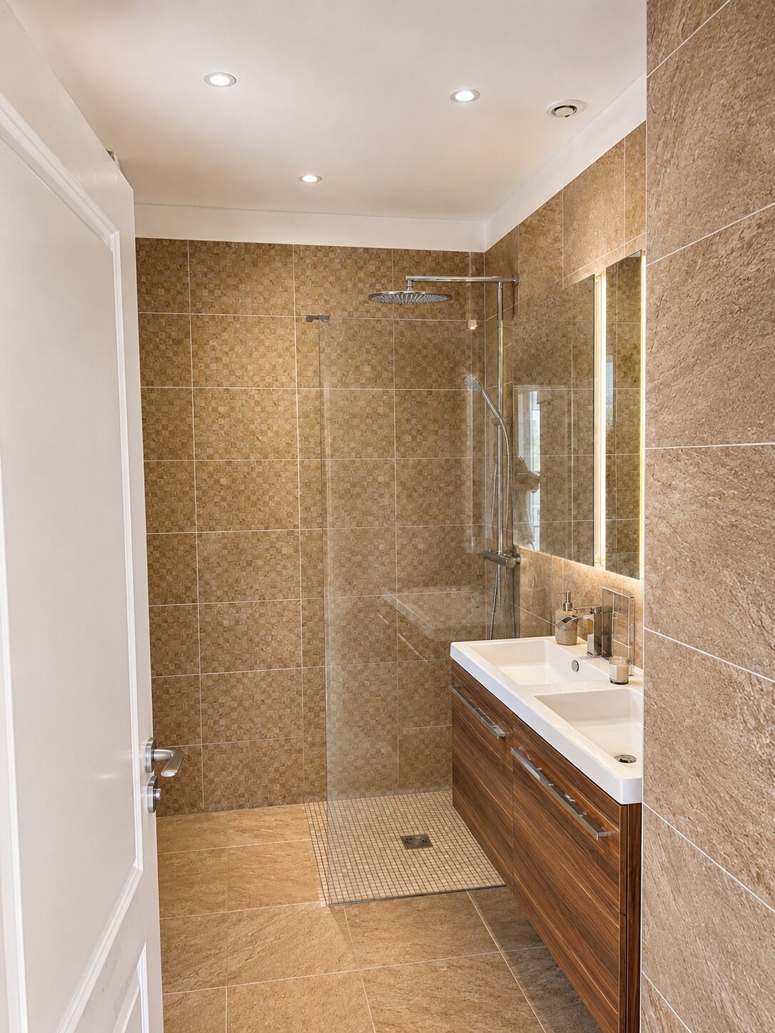 A modern bathroom with a shower, vanity, and a large mirror.