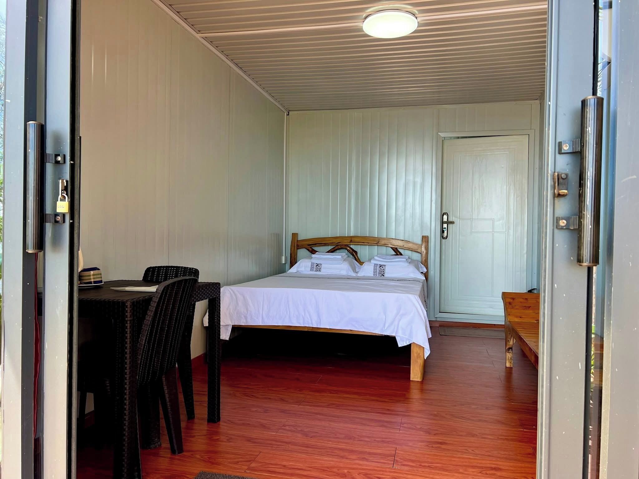A room with a bed, a desk, and a chair.