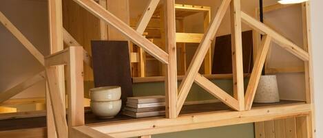 A wooden staircase with a simple design, leading to an upper level.