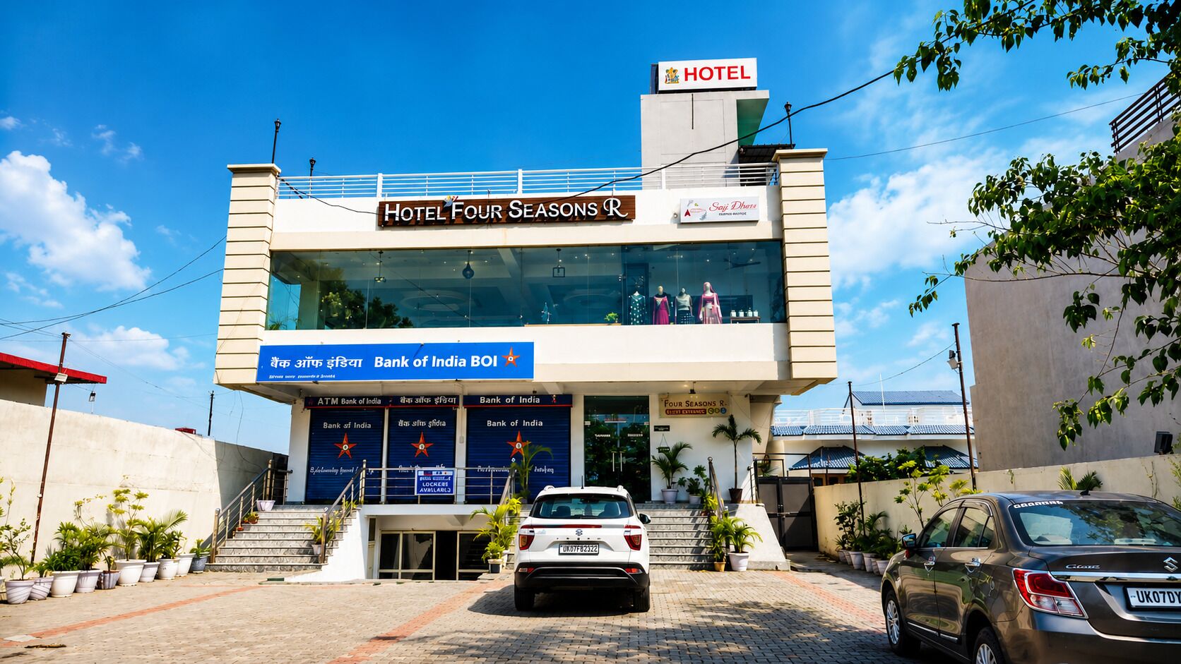 A hotel with a sign 'Hotel Four Seasons R' and 'Bank of India' ATM.