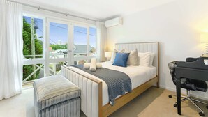 A bedroom with a bed, a desk, and a chair. - Bright Townhome with Courtyard in Neutral Bay (Neutral Bay)