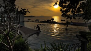 A pool area with a sunset view, boats, and a person in the water. - The Voyagers Home Borneo Kota Kinabalu (Kota Kinabalu)