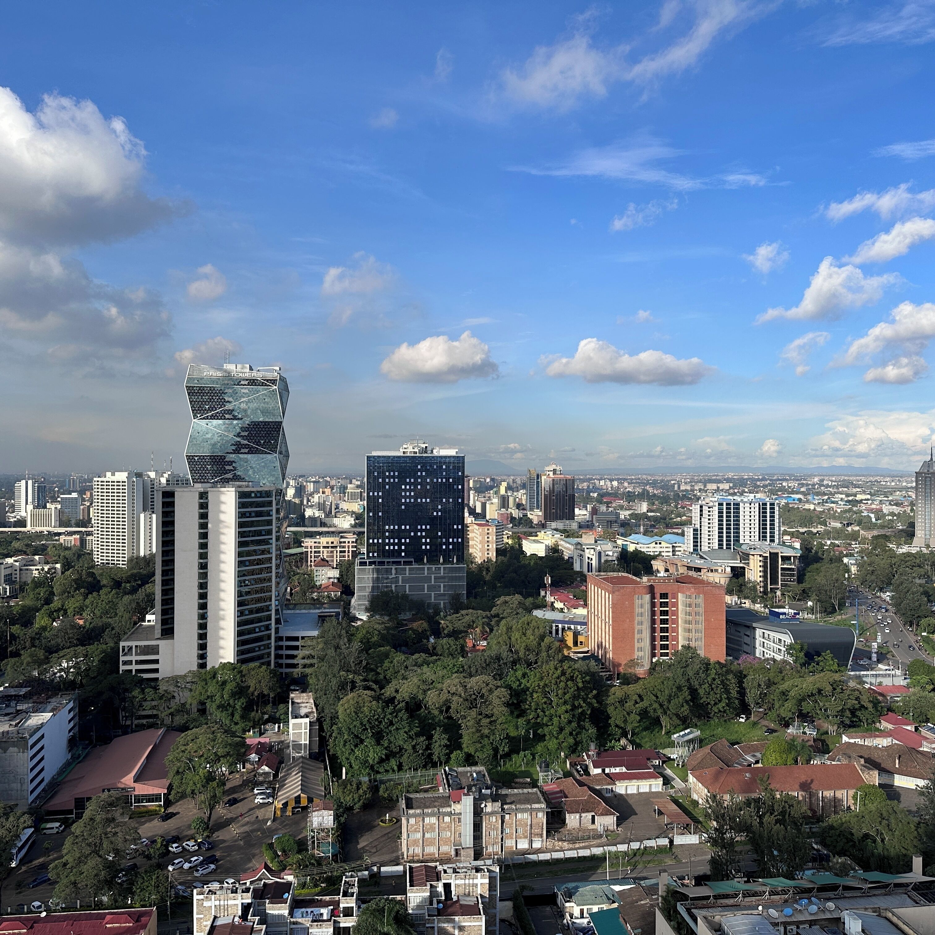 A cityscape with modern buildings, including a distinctive tower labeled 'PAIS & TOWERS.'
