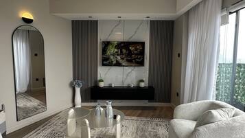 Business Apartment | Living area | 55-inch Smart TV with digital channels