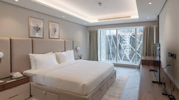 Deluxe Suite, City View | Minibar, desk, laptop workspace, iron/ironing board