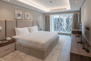 Deluxe Suite, City View | Minibar, desk, laptop workspace, iron/ironing board - Thirty Five Westbay Luxury Apartments (Doha)