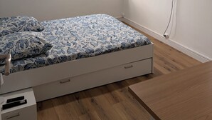 A bedroom with a bed, a ceiling fan, a TV mounted on the wall, and a window with curtains. - La Garde, Refurbished - ideal location, sleeps 8 (La Garde)
