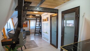 A modern interior with a staircase, a dining area, and a view through a glass door. - Barrique Milescu 5 (Brașov)