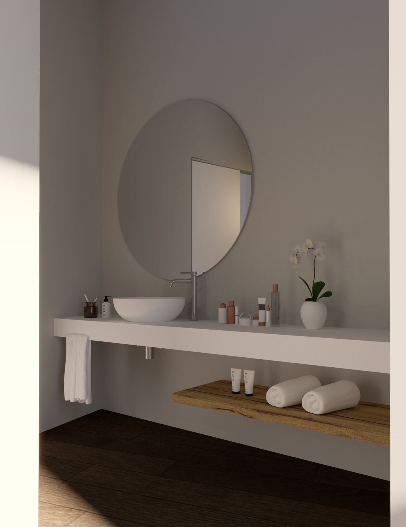 Une salle de bain avec un miroir rond, un lavabo blanc et une étagère en bois où sont rangés les articles de toilette.
