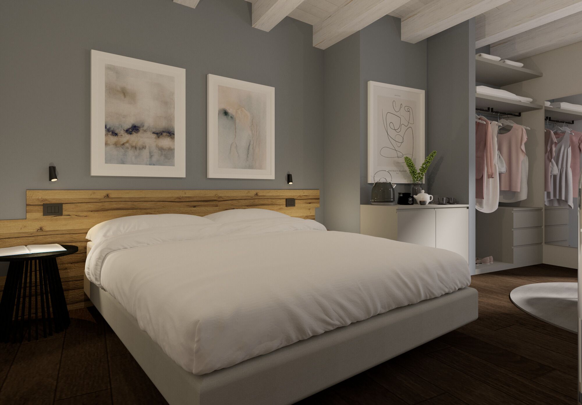 Een moderne slaapkamer met een groot bed, een houten hoofdbord, een nachtkastje en een bijzettafeltje. Er hangen twee ingelijste abstracte schilderijen aan de muur, een spiegel en een kast met daarin kleding.
