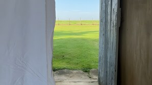A staircase leading to a grassy field with a clear sky.