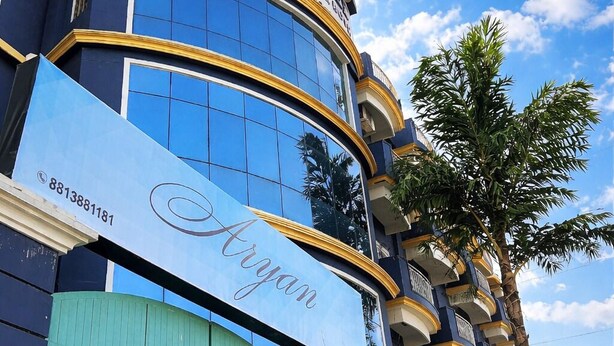 A building with a sign reading 'ARYAN HOMEY ARMYAN' and a large blue sign with 'Aryan' written on it.