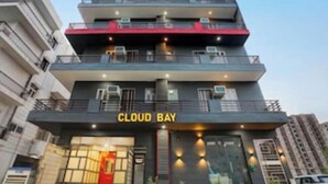 A multi-story building with balconies, a prominent 'CLOUD BAY' sign, and air conditioning units. - Cloud Bay Hotels - Sector 69 (Gurugram)