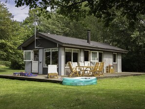 A small cabin with a porch, a hot tub, and outdoor furniture. - "Daya" - 575m from the sea by Interhome (Dannemare)