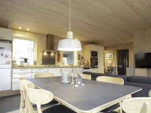 A modern kitchen with a dining area, wooden ceiling, and built-in appliances. - "Daya" - 575m from the sea by Interhome (Dannemare)