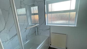 Combined shower/bathtub, deep-soaking bathtub, hair dryer, towels