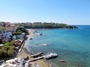 A coastal town with a beach, clear blue sea, and buildings along the shore. - Al mare by Interhome (Castiglioncello)