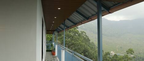 A balcony with a view of a mountainous landscape.