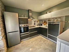 A modern kitchen with a built-in oven, a refrigerator, and a dishwasher. - Duplex standing 3 beds sea view - terrace/ Cancale (Cancale)