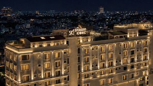 A multi-story hotel with a prominent sign reading 'SIVAKAVI ICONIC.' The building features a symmetrical facade with evenly spaced windows and balconies. - SKI - Sivakavi Iconic (Puducherry)