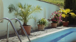 A swimming pool with potted plants along the edge. - Muskatellerhaus Holiday Home with Shared Pool, Private Terrace, and Wi-Fi (Auggen)