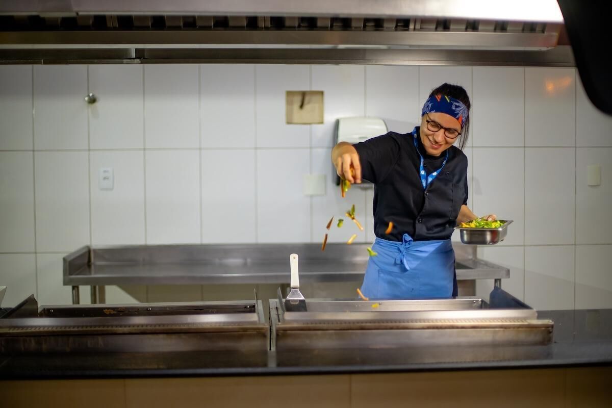 A person in a kitchen preparing food.
