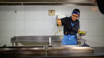 A person in a kitchen preparing food.