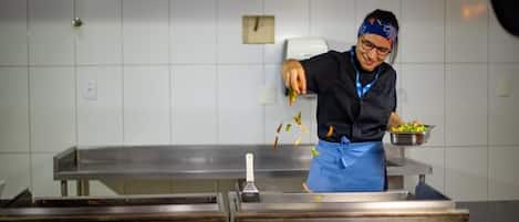 A person in a kitchen preparing food.