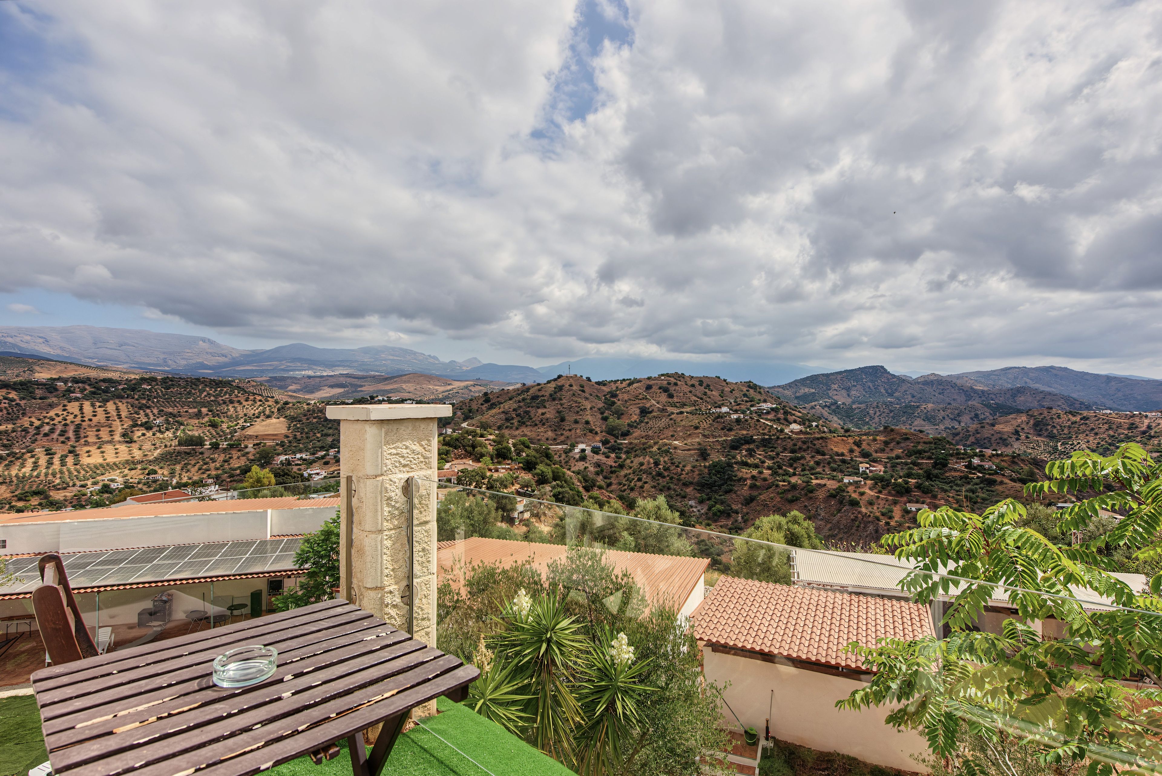 A terrace with a view of a mountainous landscape.