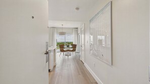 A hallway with a dining area, a large window, and a ceiling light. - Marina Majesty 7110/12-Lockout Combo-Sleeps 6 (Miramar Beach)