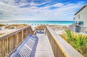 A wooden boardwalk leading to a beach with a building on the right. - Gulfview Getaway 317-Gulf Views-Sleeps 2 (Miramar Beach)