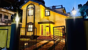 A two-story house with a gated entrance, a visible staircase, and a balcony. - Independent Bungalow for rent at Siolim. Next to main market with parking for 2 (Siolim)