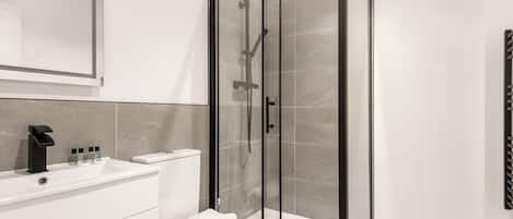 Shower, hair dryer, towels, shampoo